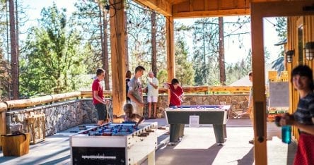 Children playing table games at Rush Creek Lodge's activity center in Yosemite.